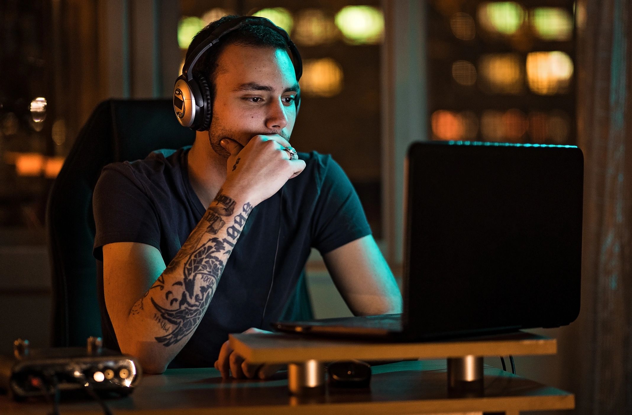 Creator working on a laptop in a home studio